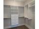 This walk-in closet features white shelving, drawers, and rods for clothing at 2235 Windsor Bluffs Dr, Cumming, GA 30041