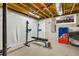Unfinished basement area with weight-lifting equipment and an accent cornhole game board at 2436 Elmwood Se Cir, Atlanta, GA 30339