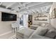 Finished basement with a large sectional sofa, television, utility sink, and storage area at 2436 Elmwood Se Cir, Atlanta, GA 30339
