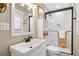 Bathroom featuring a white vanity, stylish mirror, updated shower with glass door, and tiled floors at 2436 Elmwood Se Cir, Atlanta, GA 30339
