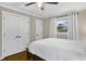 Calm bedroom featuring hardwood floors, a large window, closet space, and neutral decor at 2436 Elmwood Se Cir, Atlanta, GA 30339