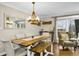 Charming dining area with a rustic wooden table, comfortable seating, and modern lighting fixture at 2436 Elmwood Se Cir, Atlanta, GA 30339