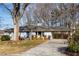 Charming single story home with mature landscaping, blue door and attached carport at 2436 Elmwood Se Cir, Atlanta, GA 30339