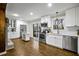Bright kitchen featuring white cabinetry, stainless steel appliances, hardwood floors, and access to an outdoor deck at 2436 Elmwood Se Cir, Atlanta, GA 30339