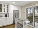 Open kitchen featuring a stainless steel refrigerator, center island, white cabinetry, and outdoor access at 2436 Elmwood Se Cir, Atlanta, GA 30339