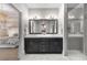Modern bathroom with a double vanity, marble countertops, and a glass-enclosed shower, adjacent to the bedroom at 304 Stonemont Dr, Atlanta, GA 30305
