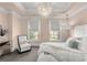 Bright bedroom with a statement chandelier, plush bedding, and soft lighting at 304 Stonemont Dr, Atlanta, GA 30305