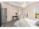 Elegant bedroom with a tray ceiling, modern chandelier, and natural light from two windows at 304 Stonemont Dr, Atlanta, GA 30305