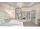 Stylish bedroom with a chic chandelier, mirrored accents, and neutral color palette at 304 Stonemont Dr, Atlanta, GA 30305
