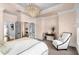 Inviting bedroom showcases a modern chandelier, comfortable chair, and calming color scheme at 304 Stonemont Dr, Atlanta, GA 30305