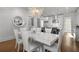 Bright open-concept dining room features a modern white table set and views of the eat-in kitchen at 304 Stonemont Dr, Atlanta, GA 30305