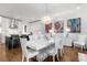 Open-concept dining area connected to the kitchen features a modern table, pendant lighting, and vibrant wall art at 304 Stonemont Dr, Atlanta, GA 30305