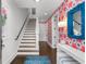 Inviting foyer with hardwood floors, staircase, colorful wallpaper, and modern decor at 304 Stonemont Dr, Atlanta, GA 30305