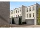 Beautiful townhome exteriors with garage access and brick-paved driveway, complemented by landscaping at 304 Stonemont Dr, Atlanta, GA 30305