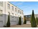 Charming white townhomes featuring garage doors and brick driveway with manicured landscaping at 304 Stonemont Dr, Atlanta, GA 30305