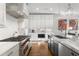 Gourmet kitchen featuring marble countertops, stainless steel appliances, and custom white cabinetry at 304 Stonemont Dr, Atlanta, GA 30305