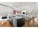 Modern kitchen with island, stainless steel appliances, and open layout to the dining and living areas at 304 Stonemont Dr, Atlanta, GA 30305