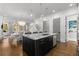Spacious kitchen featuring a marble island, stainless steel appliances, and open layout to the dining area at 304 Stonemont Dr, Atlanta, GA 30305