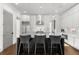 Bright kitchen boasts a marble island, stainless appliances, stylish pendant lights, and white cabinets at 304 Stonemont Dr, Atlanta, GA 30305