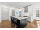 Bright kitchen boasts a marble island, stainless appliances, stylish pendant lights, and white cabinets at 304 Stonemont Dr, Atlanta, GA 30305