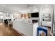 Open-concept living room with hardwood floors, modern lighting, and a kitchen and dining area in the background at 304 Stonemont Dr, Atlanta, GA 30305