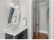Stylish powder room with checkered wallpaper and modern fixtures at 304 Stonemont Dr, Atlanta, GA 30305