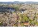 Aerial view of a wooded property near a lake at 3510 Riviera Dr, Cumming, GA 30041