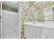 Bathroom features a tiled floor, bathtub-shower combination, and floral wallpaper at 3638 Clark Hill Way, Buford, GA 30519