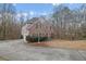 Brick home shows garage and paved drive in wooded setting at 3638 Clark Hill Way, Buford, GA 30519