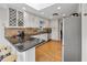 Kitchen with white cabinets, built-in wine rack, and stainless steel appliances at 8498 Colony Club Dr, Alpharetta, GA 30022