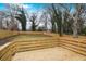 Fenced backyard with a wood deck and shade trees; perfect for outdoor activities and relaxation at 1459 Kenilworth Sw Dr, Atlanta, GA 30310