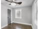 This bedroom features hardwood floors, gray walls, one window with wood blinds, and a gray painted door at 1459 Kenilworth Sw Dr, Atlanta, GA 30310