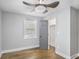 This bedroom features hardwood floors, gray walls, a window with wood blinds, and a gray painted door at 1459 Kenilworth Sw Dr, Atlanta, GA 30310