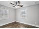This bedroom features hardwood floors, gray walls, two windows with wood blinds, and a ceiling fan with lighting at 1459 Kenilworth Sw Dr, Atlanta, GA 30310
