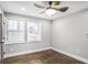 This bedroom features hardwood floors, gray walls, two windows with wood blinds, and a ceiling fan with lighting at 1459 Kenilworth Sw Dr, Atlanta, GA 30310