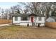 Charming home features a red front door, white siding, and a well-manicured lawn at 1459 Kenilworth Sw Dr, Atlanta, GA 30310