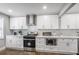 Modern kitchen boasts white cabinetry, stainless steel appliances, and plenty of counter space at 1459 Kenilworth Sw Dr, Atlanta, GA 30310