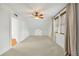 Spacious bedroom with neutral carpet, ceiling fan, and windows covered with woven wooden shades at 1590 N Morningside Ne Dr, Atlanta, GA 30306