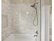 This renovated shower features subway tile, a built-in niche, and a glass shower door at 1590 N Morningside Ne Dr, Atlanta, GA 30306