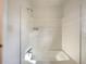 Bright white bathroom with shower and tub combo, featuring chrome fixtures at 7330 White Flag Trl, Lithia Springs, GA 30122