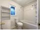 Bright bathroom with a tub and shower combination and white cabinetry at 7330 White Flag Trl, Lithia Springs, GA 30122