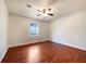 Well-lit bedroom features ceiling fan, window, and sleek wood flooring at 7330 White Flag Trl, Lithia Springs, GA 30122