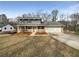 Charming two-story home featuring stone accents, a welcoming front porch, and a well-maintained front yard at 7330 White Flag Trl, Lithia Springs, GA 30122