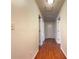 Hallway with wood floors and white walls, leading to multiple rooms at 7330 White Flag Trl, Lithia Springs, GA 30122
