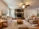 Bright living room with a stone fireplace, plush furniture, and a cozy rug for comfortable living at 7330 White Flag Trl, Lithia Springs, GA 30122