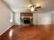 Spacious living room featuring a stone fireplace with a hearth and hardwood floors at 7330 White Flag Trl, Lithia Springs, GA 30122