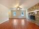 Bright living room featuring hardwood floors and a stone fireplace at 7330 White Flag Trl, Lithia Springs, GA 30122