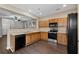 Well-equipped kitchen with stainless steel appliances, wood cabinets, and a view into the living area at 131 Ellis Dr, Conyers, GA 30012