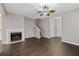Spacious living room features a cozy fireplace, modern ceiling fan, and a staircase leading to the upper level at 131 Ellis Dr, Conyers, GA 30012