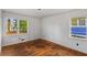 Light-filled bedroom featuring hardwood floors and two windows, providing ample natural light and neighborhood views at 1599 Mayflower Sw Ave, Atlanta, GA 30311